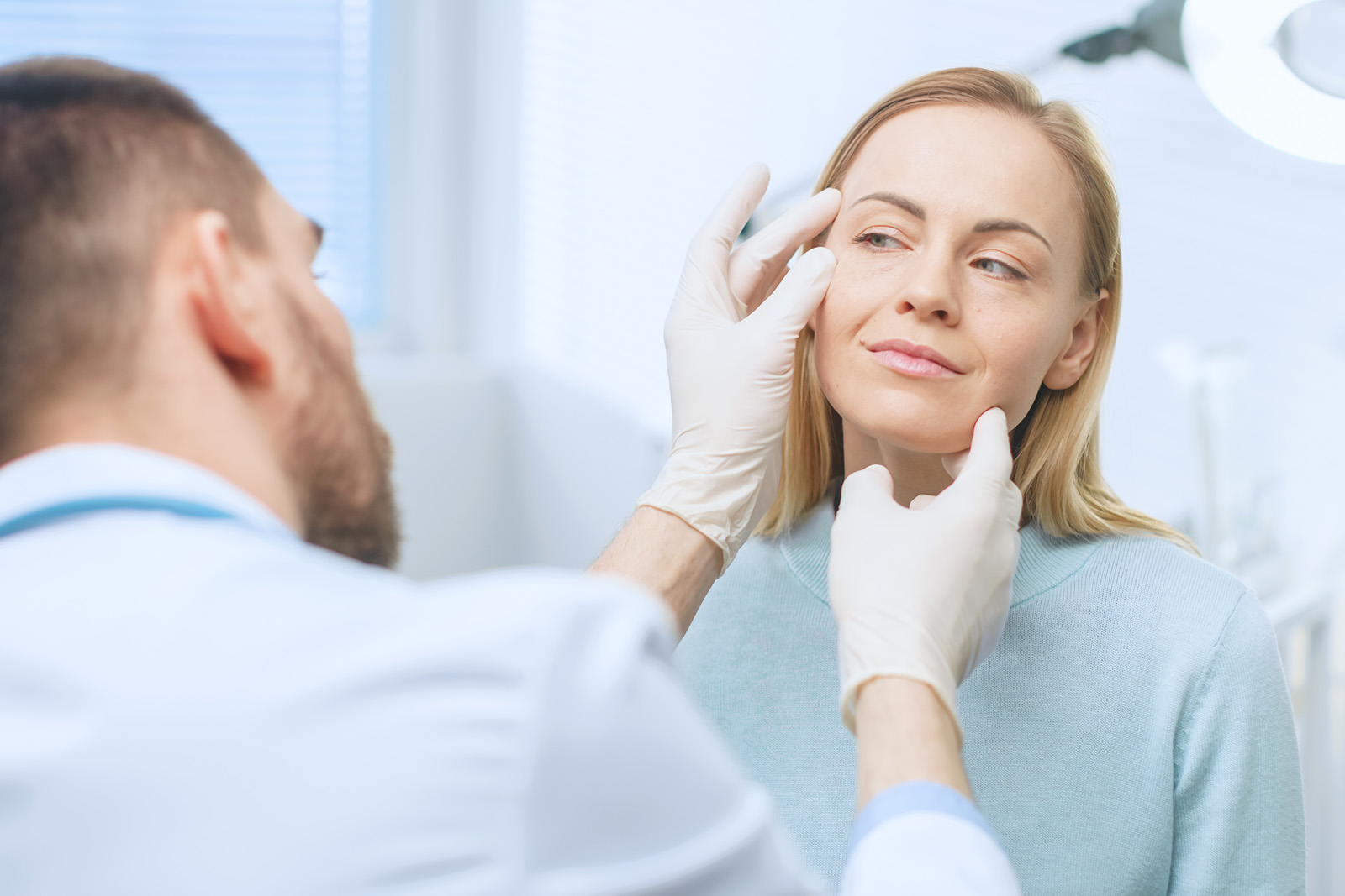 Plastic / Cosmetic Surgeon Examines Beautiful Woman's Face, Touches it with Gloved Hands, Inspecting Healed Face after Plastic Surgery with Amazing Results