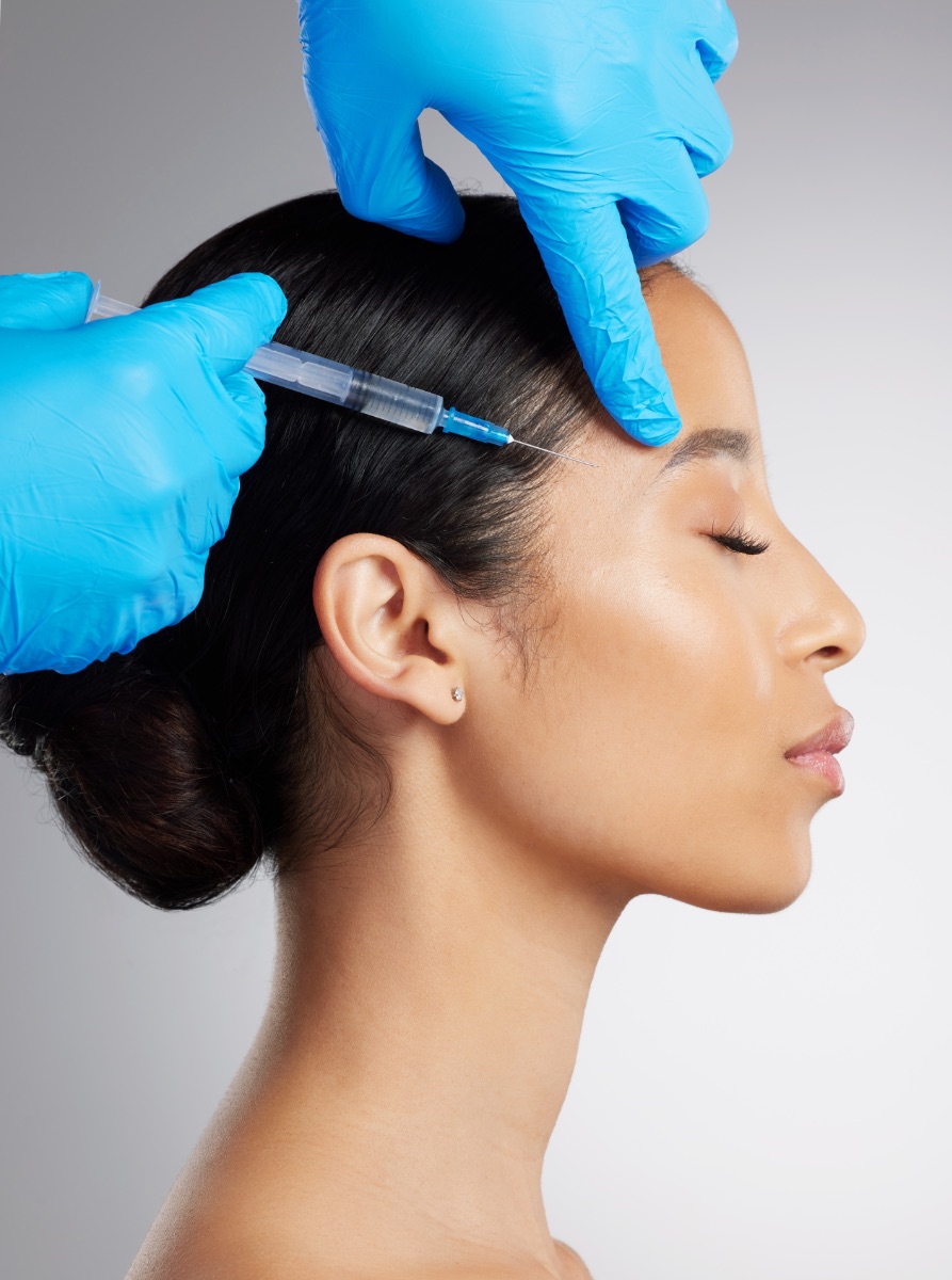 Skincare, studio and woman with injection for dermal filler, plastic surgery or anti aging treatment. Profile, syringe and person with facial cosmetics, mesotharapy or beauty on white background